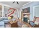 Cozy living room features a decorative fireplace, hardwood floors and modern furnishings at 813 Burch Ave, Durham, NC 27701