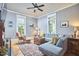 Bright living room boasts hardwood floors, large windows, and comfortable seating area at 813 Burch Ave, Durham, NC 27701