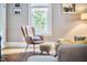 Living room featuring hardwood floors, area rug, leather chair and ample natural light at 813 Burch Ave, Durham, NC 27701