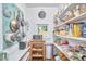 Well-organized pantry with shelves full of goods and hanging pots and pans at 813 Burch Ave, Durham, NC 27701
