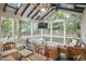 Inviting screened porch with lounge furniture, a dining area, and scenic backyard views at 813 Burch Ave, Durham, NC 27701