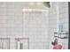 Close-up of a shower featuring white subway tiles, recessed shelving, and modern fixtures at 813 Burch Ave, Durham, NC 27701