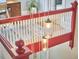 View of the red and white staircase with hanging jar lights and natural light at 813 Burch Ave, Durham, NC 27701