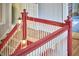 View of the red and white staircase with hanging jar lights and natural light at 813 Burch Ave, Durham, NC 27701