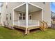 Back porch with white railings and wooden steps, offering a cozy outdoor space at 825 Abbyberry Dr, Wake Forest, NC 27587
