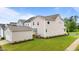 Spacious backyard with a detached garage and well-manicured lawn, perfect for outdoor activities at 825 Abbyberry Dr, Wake Forest, NC 27587