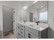 Elegant bathroom featuring double vanity with gray cabinets, a large mirror, and stylish fixtures at 825 Abbyberry Dr, Wake Forest, NC 27587