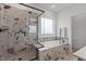 Modern bathroom featuring glass shower, separate tub with tile surround, and large window at 825 Abbyberry Dr, Wake Forest, NC 27587