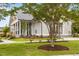 Attractive clubhouse exterior with manicured lawn, pillars, and gray siding on a sunny day at 825 Abbyberry Dr, Wake Forest, NC 27587