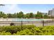 Large fenced community pool with lounge chairs and tables, surrounded by lush greenery and buildings at 825 Abbyberry Dr, Wake Forest, NC 27587