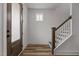 Bright entryway features wood-look flooring, staircase, and a front door with sidelight window at 825 Abbyberry Dr, Wake Forest, NC 27587
