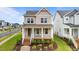 Charming two-story home with a welcoming front porch and landscaped front yard at 825 Abbyberry Dr, Wake Forest, NC 27587