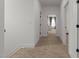 Inviting hallway with carpet, showcasing access to various rooms in this home at 825 Abbyberry Dr, Wake Forest, NC 27587