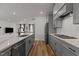 Open kitchen with modern appliances, island with sink and breakfast bar, and hardwood floors at 825 Abbyberry Dr, Wake Forest, NC 27587