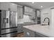 Modern kitchen with stainless steel appliances, gas cooktop, grey cabinets and bright countertops at 825 Abbyberry Dr, Wake Forest, NC 27587