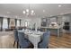 Open-concept home design showcases a dining area, living space, and a modern kitchen with island at 825 Abbyberry Dr, Wake Forest, NC 27587