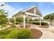 Community picnic pavilion featuring a concrete floor, picnic tables, and lush landscaping at 825 Abbyberry Dr, Wake Forest, NC 27587