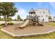 Community playground with a slide, climbing structures, and soft wood chip ground cover at 825 Abbyberry Dr, Wake Forest, NC 27587