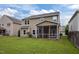 Expansive backyard featuring well-kept lawn and a screened porch perfect for outdoor relaxation and entertaining at 831 Poplar St, Durham, NC 27703