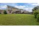 This backyard features a screened in porch with an ample, well maintained lawn at 831 Poplar St, Durham, NC 27703