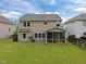 Large backyard with green grass, a screened-in porch, and views of neighboring homes at 831 Poplar St, Durham, NC 27703