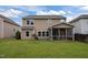 Spacious backyard with a well-maintained lawn, screened porch, and ample space for outdoor activities at 831 Poplar St, Durham, NC 27703