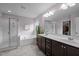 Bright bathroom featuring a double vanity, soaking tub, and separate shower at 831 Poplar St, Durham, NC 27703