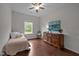 Bright bedroom with hardwood floors, window, and peaceful decor at 831 Poplar St, Durham, NC 27703