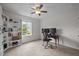 Cozy bedroom featuring a ceiling fan, window, and desk at 831 Poplar St, Durham, NC 27703