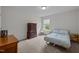 Comfortable bedroom with a neutral palette and a serene window view at 831 Poplar St, Durham, NC 27703
