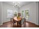 Cozy dining area features a modern light fixture, backyard access, and wood floors at 831 Poplar St, Durham, NC 27703