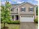 Charming two-story home with a two car garage, manicured lawn and beautiful, mature landscaping at 831 Poplar St, Durham, NC 27703