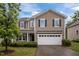 Attractive two-story home with a two-car garage, complemented by neatly trimmed bushes and a well-kept lawn at 831 Poplar St, Durham, NC 27703