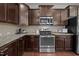 Well-appointed kitchen boasts granite counters and stainless appliances at 831 Poplar St, Durham, NC 27703