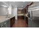 Galley kitchen offers stainless appliances, granite counters, and dark wood cabinets at 831 Poplar St, Durham, NC 27703