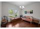 Sitting room with hardwood floors, many windows and a stylish sofa at 831 Poplar St, Durham, NC 27703