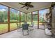 The screened porch has a ceiling fan and overlooks the large yard and wooded area at 831 Poplar St, Durham, NC 27703