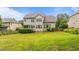 Spacious backyard featuring a deck, lush lawn, and mature landscaping providing ample space for outdoor activities at 9013 Dansforeshire Way, Wake Forest, NC 27587
