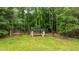 Backyard aerial view including a covered gazebo, trampoline, basketball court, lush yard and mature trees at 9013 Dansforeshire Way, Wake Forest, NC 27587