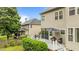 Back of house, including screened in porch with a deck area, mature landscaping and a multi-level yard at 9013 Dansforeshire Way, Wake Forest, NC 27587
