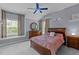 Cozy bedroom with blue walls, ceiling fan and plush pink bedding at 9013 Dansforeshire Way, Wake Forest, NC 27587