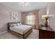 Bedroom featuring a modern bed frame and neutral pink decor at 9013 Dansforeshire Way, Wake Forest, NC 27587