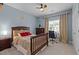 Inviting bedroom with dark wood furniture and a desk and workspace near the window at 9013 Dansforeshire Way, Wake Forest, NC 27587