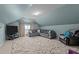 Bonus room featuring a large gray sectional sofa, modern television and a soft and plush area rug at 9013 Dansforeshire Way, Wake Forest, NC 27587
