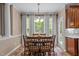 Formal dining room with large windows, neutral walls, elegant lighting, and hardwood floors at 9013 Dansforeshire Way, Wake Forest, NC 27587