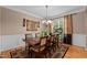 Classic dining room featuring a wooden table, six chairs, and a decorative chandelier and carpet at 9013 Dansforeshire Way, Wake Forest, NC 27587
