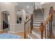 Elegant foyer with hardwood flooring, stairs, and decorative arches for a grand entrance at 9013 Dansforeshire Way, Wake Forest, NC 27587