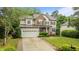 Charming home featuring a two-car garage, stone accents, manicured lawn, and inviting curb appeal at 9013 Dansforeshire Way, Wake Forest, NC 27587
