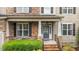 Inviting front porch with stone pillars and space to sit and enjoy the outdoors at 9013 Dansforeshire Way, Wake Forest, NC 27587