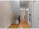 Hallway with hardwood flooring leading to stairs and a bedroom at 9013 Dansforeshire Way, Wake Forest, NC 27587